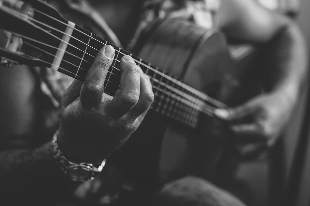 Elena Rodriguez performing with acoustic guitar on stage